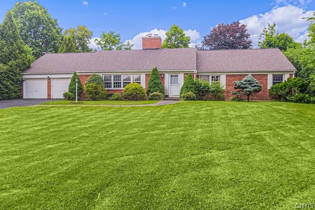 ranch-style home with a garage and a front lawn