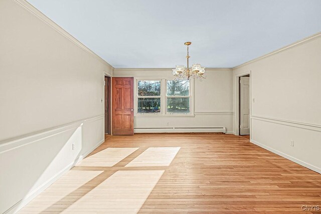 unfurnished dining area featuring a notable chandelier, light wood-type flooring, crown molding, and a baseboard radiator