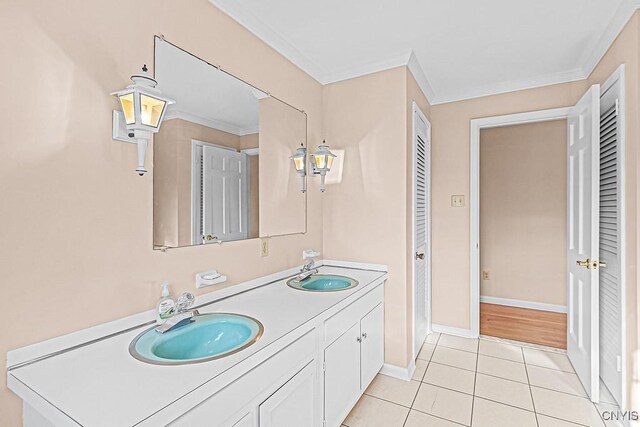 bathroom with tile patterned flooring, vanity, and crown molding