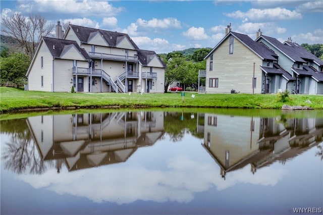 exterior space with a water view and a yard