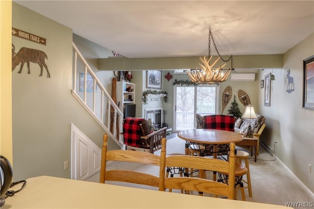 dining room featuring a wall unit AC, carpet floors, and an inviting chandelier