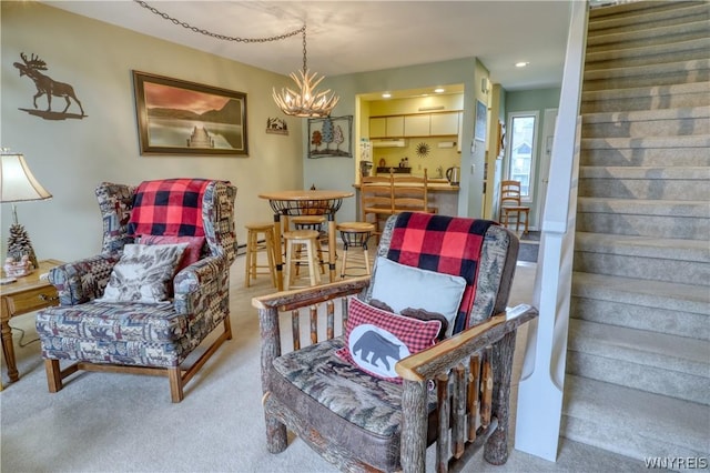 carpeted living room with an inviting chandelier