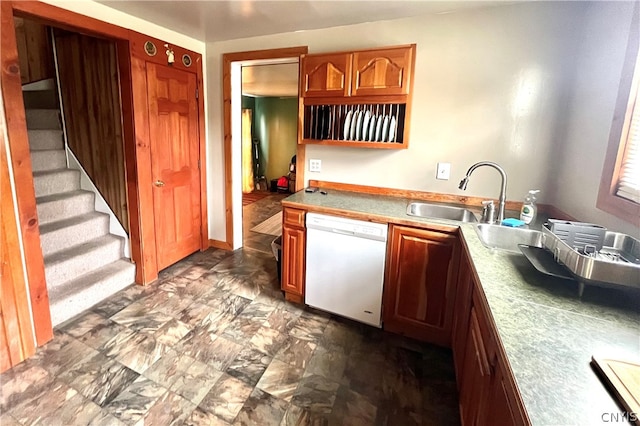 kitchen featuring dishwasher and dark tile floors