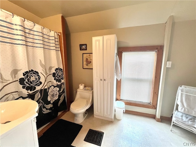 bathroom with tile floors, toilet, and vanity