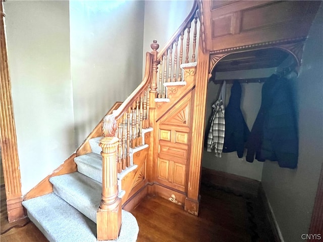 staircase with dark wood-type flooring