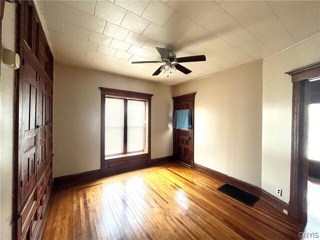 spare room with ceiling fan and light wood-type flooring