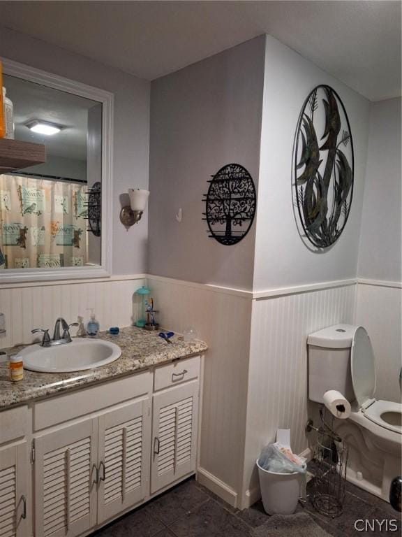 bathroom with tile patterned flooring, vanity, and toilet