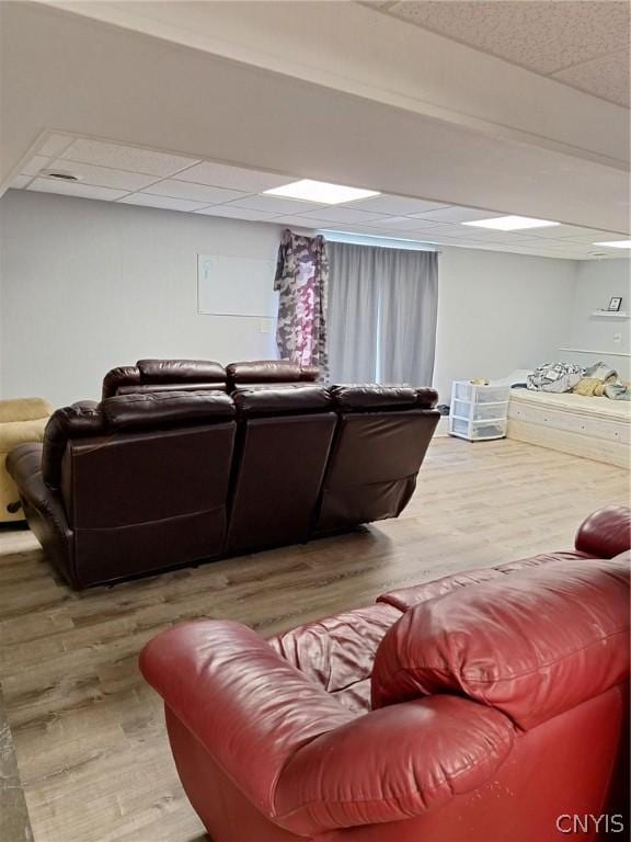 living room with a paneled ceiling and hardwood / wood-style flooring