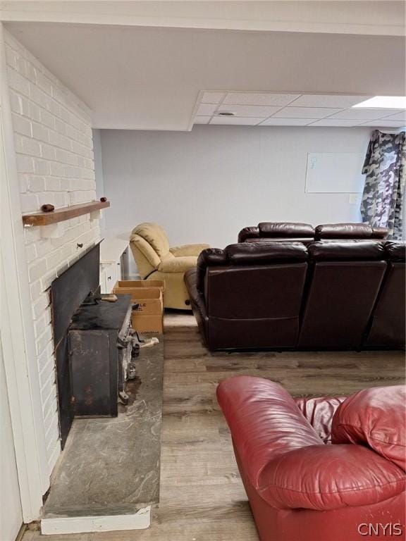 living room featuring hardwood / wood-style floors and a brick fireplace