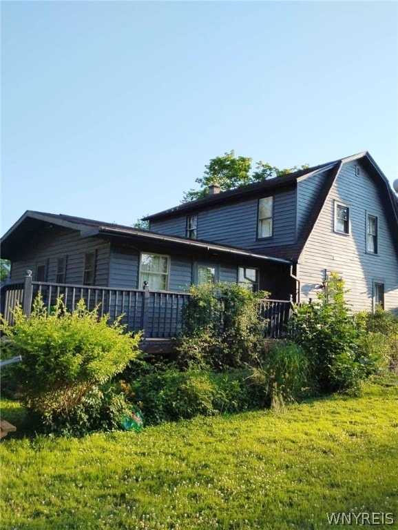 rear view of house featuring a lawn