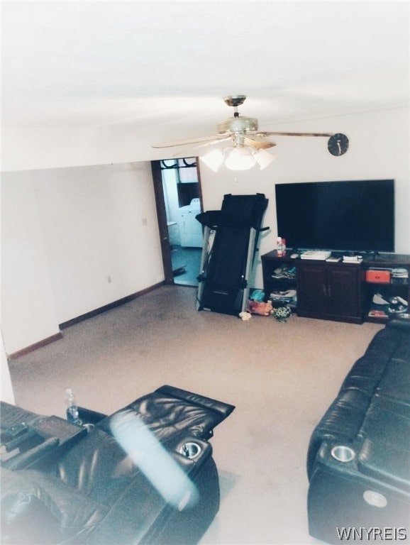 carpeted living room with ceiling fan