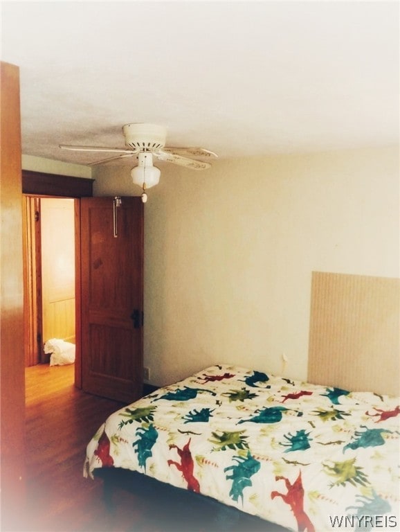 bedroom featuring ceiling fan and dark hardwood / wood-style floors