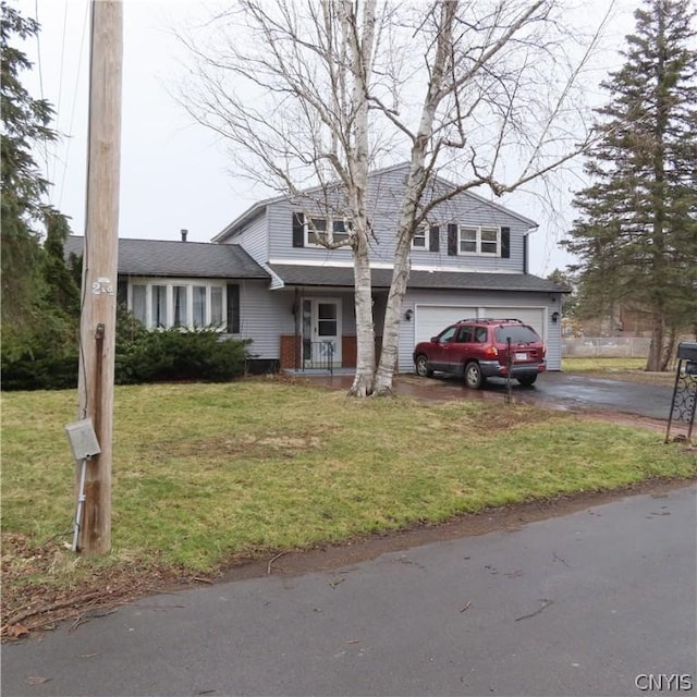 view of front of property featuring a front lawn and a garage