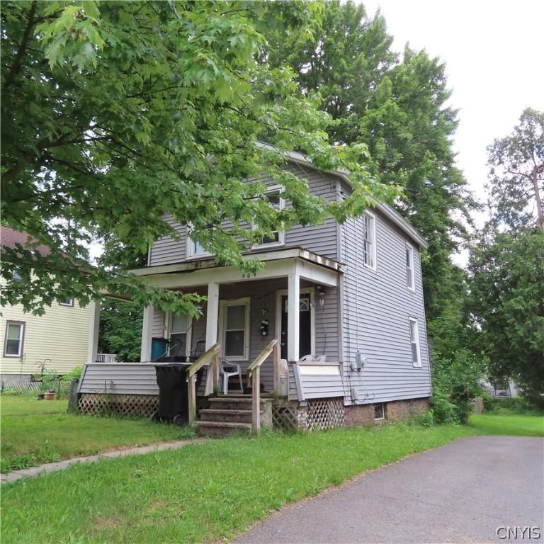 bungalow with a front yard and a porch