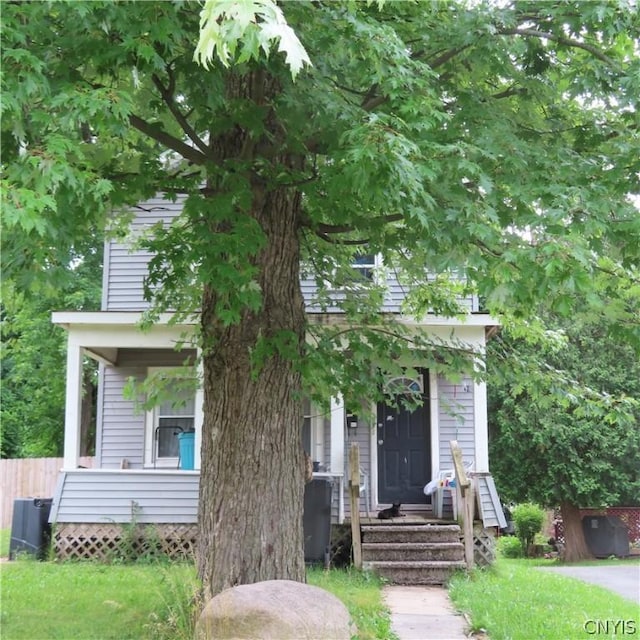 obstructed view of property featuring a front yard