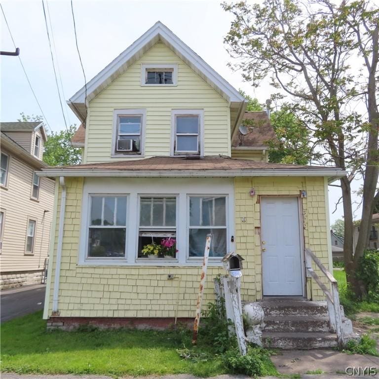 rear view of property with cooling unit