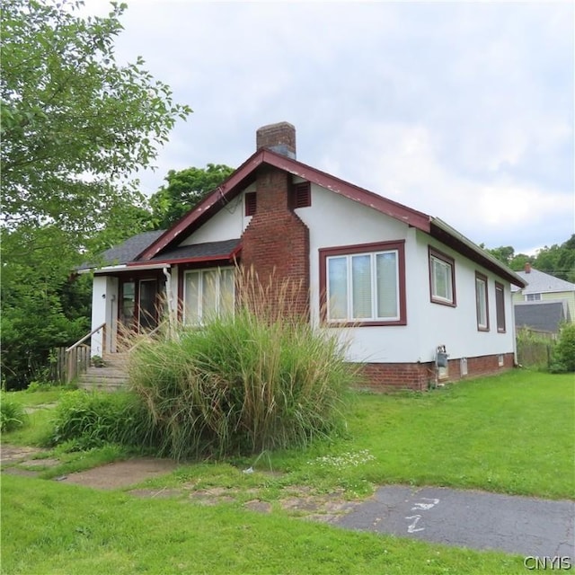 view of side of home featuring a lawn