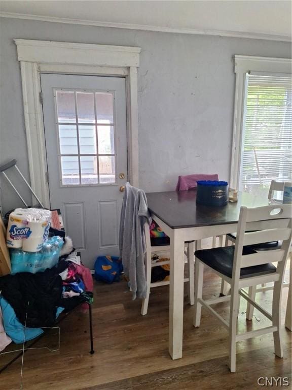 dining space featuring hardwood / wood-style floors and crown molding