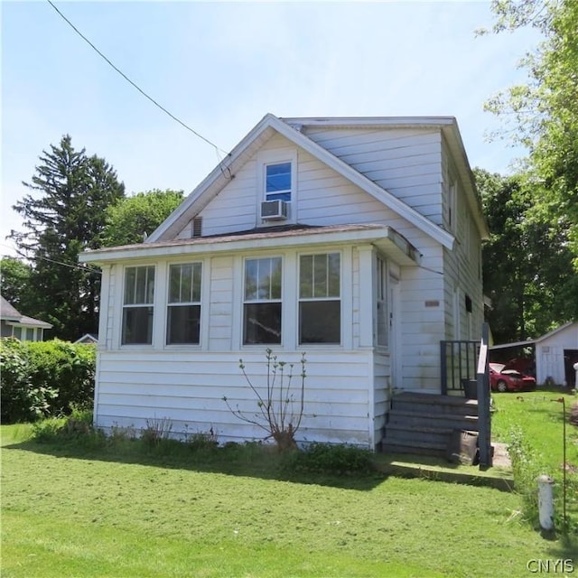 view of side of home featuring cooling unit and a lawn