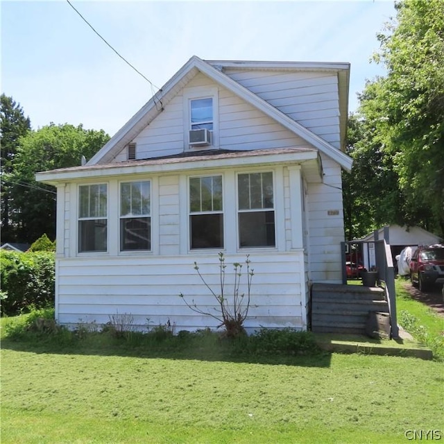 view of side of home with a yard and cooling unit