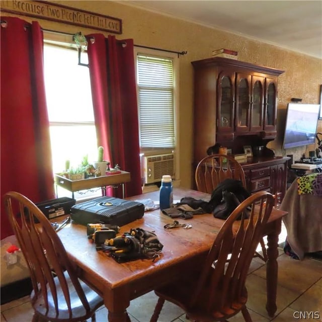 dining area featuring cooling unit and light tile patterned flooring