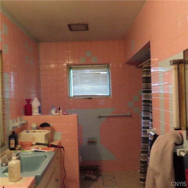 bathroom featuring vanity and curtained shower