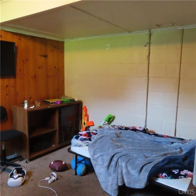 carpeted bedroom with wood walls