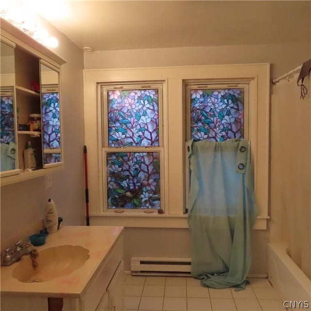 bathroom featuring tile patterned flooring, vanity, a baseboard radiator, and shower / bath combo with shower curtain