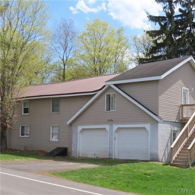 view of property exterior with a yard and a garage