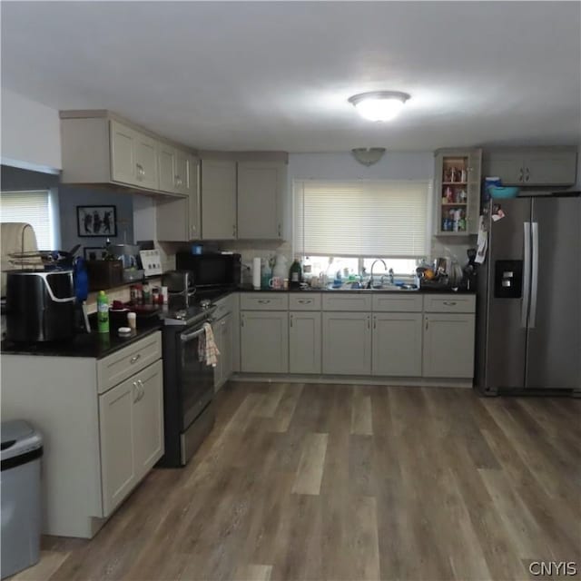 kitchen featuring appliances with stainless steel finishes, hardwood / wood-style flooring, and sink