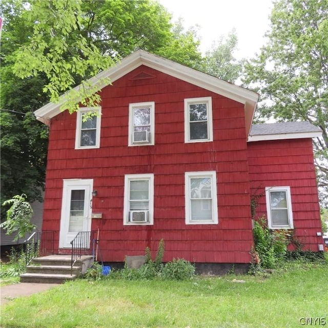 view of side of home featuring a yard