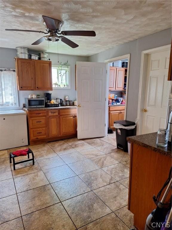 kitchen featuring a textured ceiling and ceiling fan