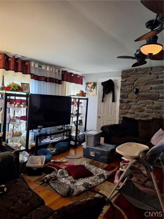 living room featuring hardwood / wood-style flooring and ceiling fan