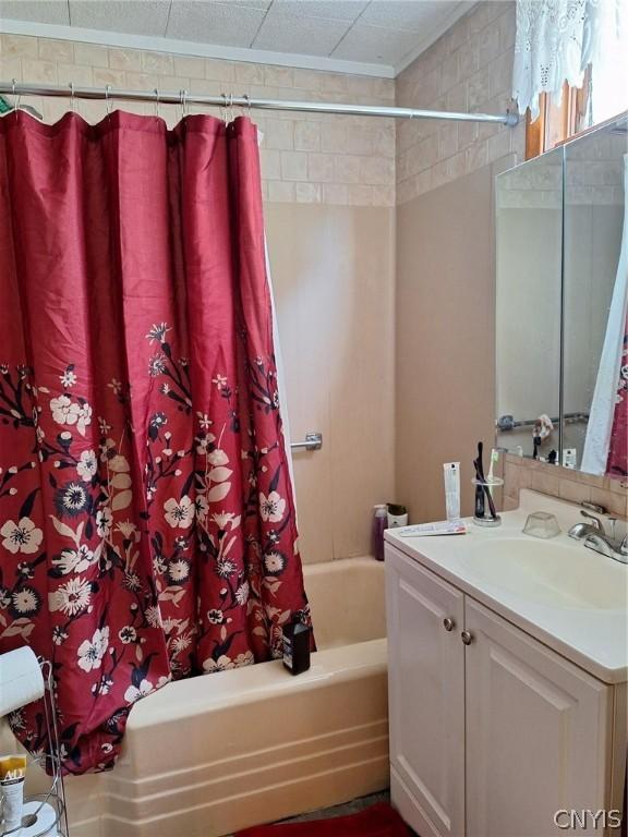 bathroom with shower / bath combination with curtain and vanity