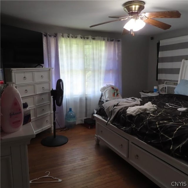 bedroom with ceiling fan and dark hardwood / wood-style floors