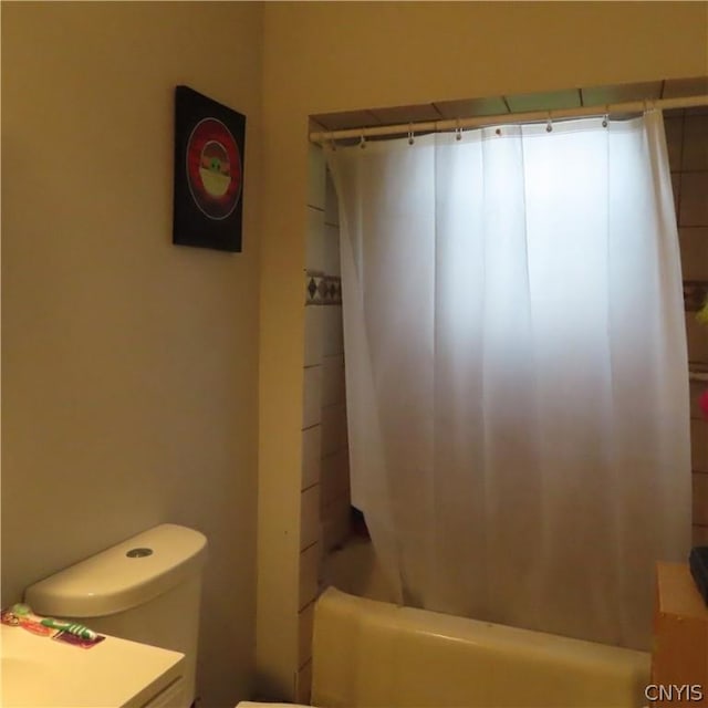 bathroom with toilet and shower / bathtub combination with curtain