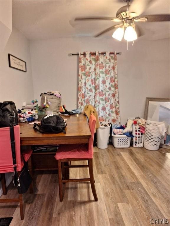 dining space with hardwood / wood-style flooring and ceiling fan