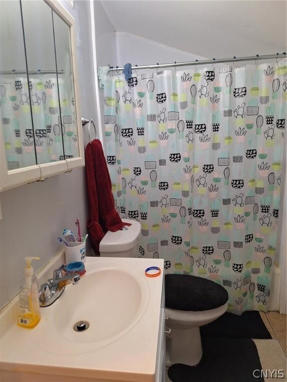 full bathroom featuring tile patterned flooring, vanity, toilet, and shower / tub combo