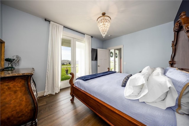 bedroom featuring a chandelier, dark hardwood / wood-style floors, and billiards