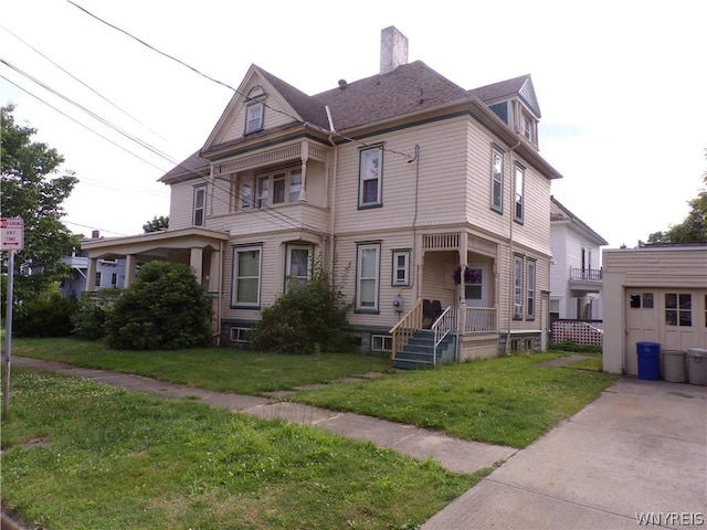 view of front facade featuring a chimney and a front yard