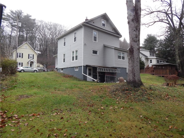 back of house with a wooden deck and a yard