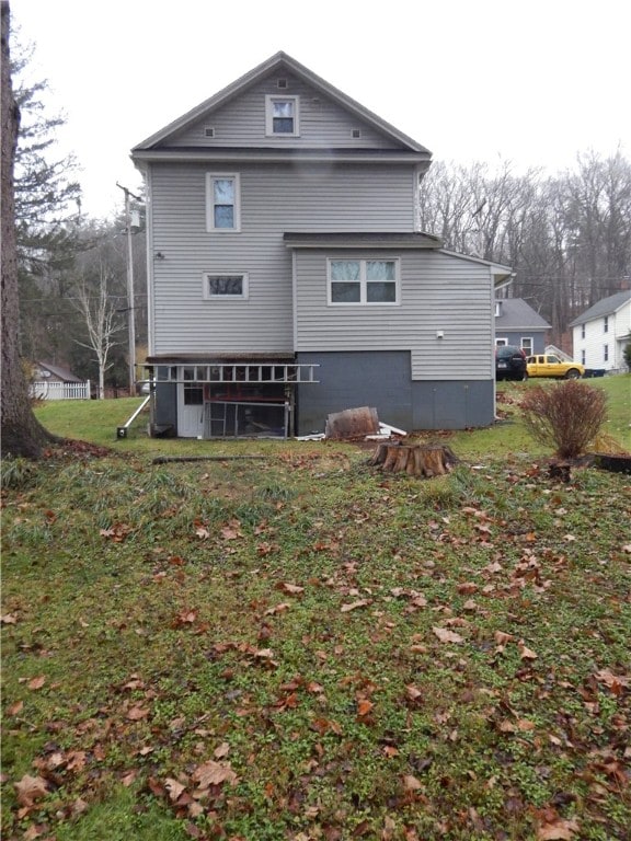 rear view of property with a yard