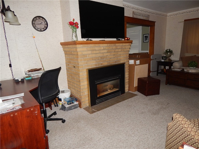 carpeted home office featuring crown molding and a brick fireplace