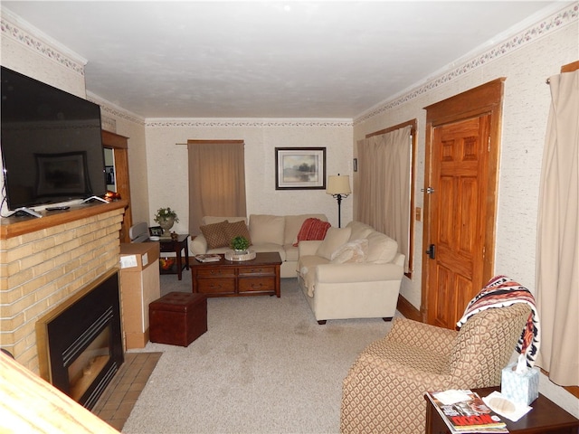 living room with crown molding, carpet, and a brick fireplace