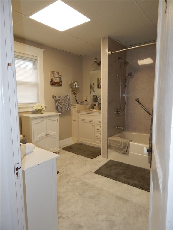 bathroom with tile flooring, vanity, and tiled shower / bath combo