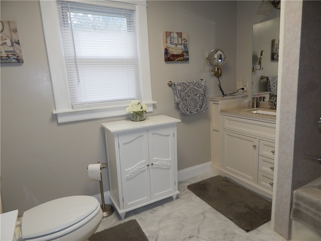 bathroom with tile flooring, vanity, and toilet