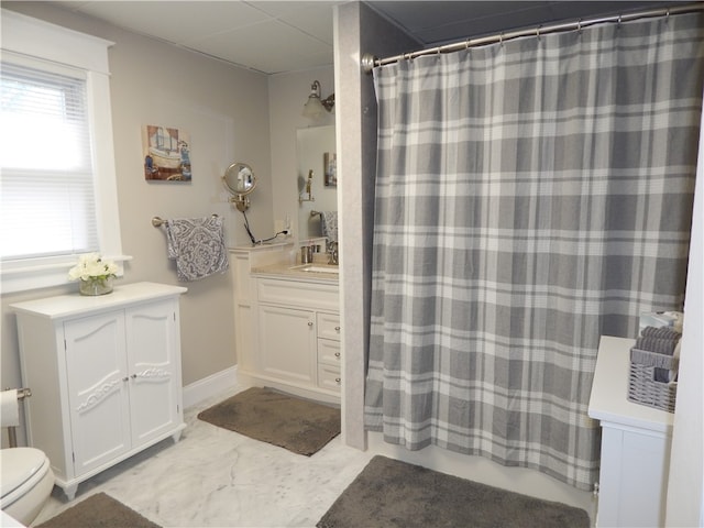 bathroom with tile floors, toilet, and vanity