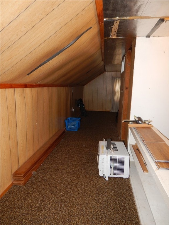 additional living space with carpet flooring, wood ceiling, and wood walls