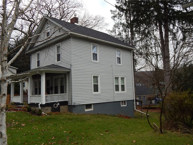 view of home's exterior featuring a lawn and a porch