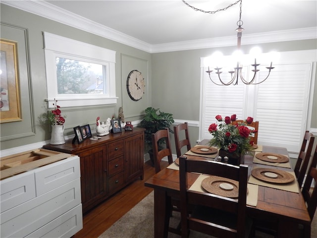 dining space with a notable chandelier, dark hardwood / wood-style flooring, and crown molding